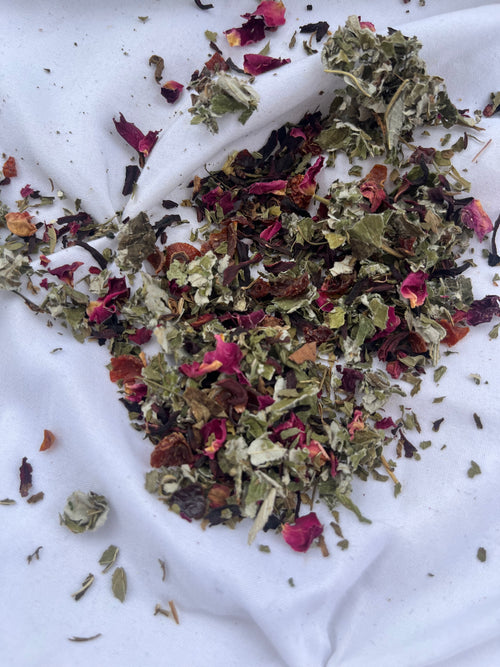 Dry herbs and flowers on a white fabric background